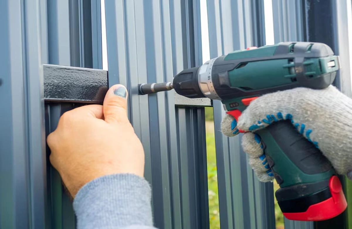 Expert technician installing a durable metal gate, showcasing professional new gate installation in Houston for lasting security.