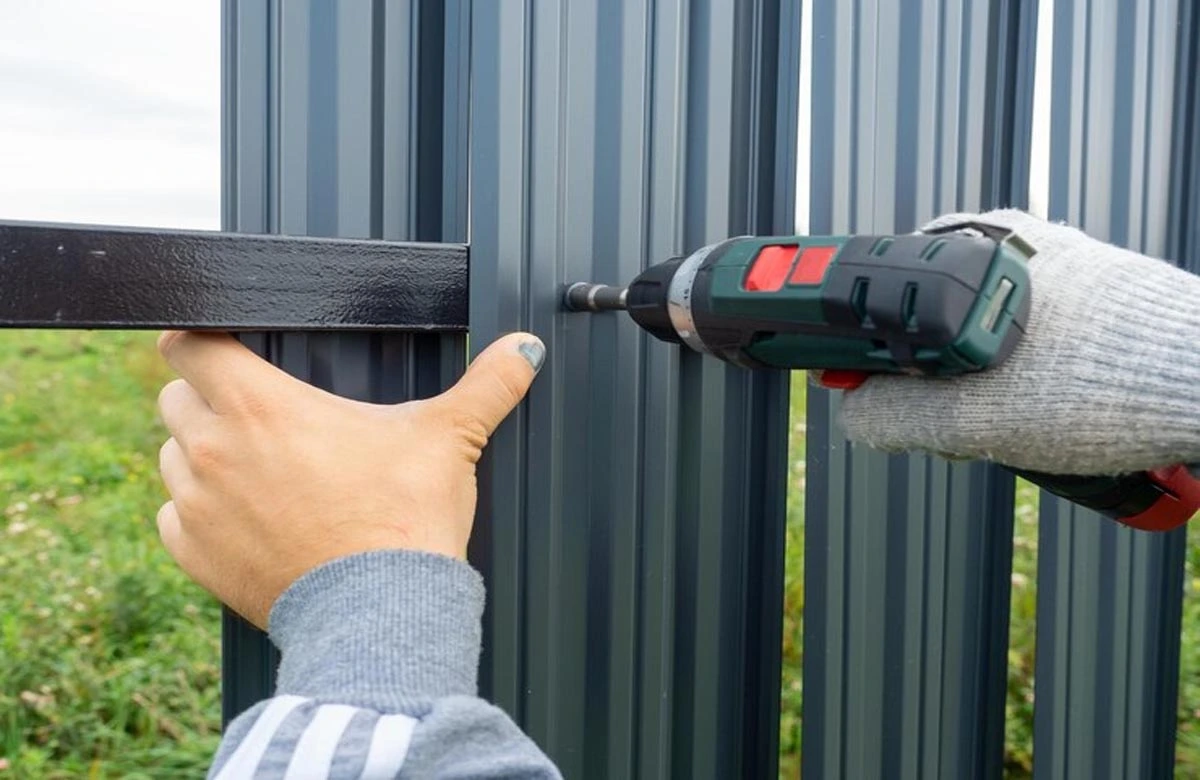 Skilled technician performing residential gate repair using high-grade tools to ensure strong and secure gate panels. We offer durable solutions for damaged or worn-out metal gates.