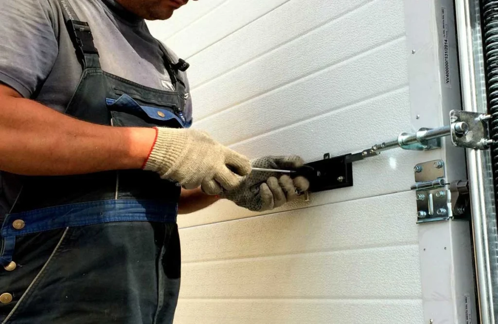Close-up of a technician fixing a garage door spring system, part of reliable gate repair services in Houston.