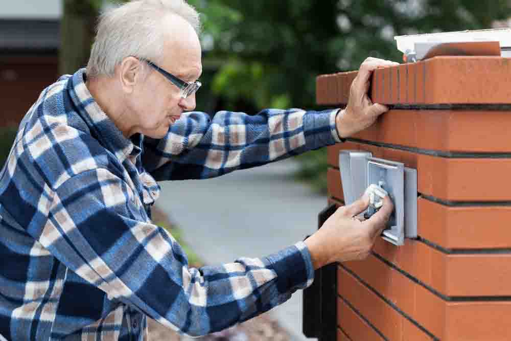Technician fixing sliding gate opener